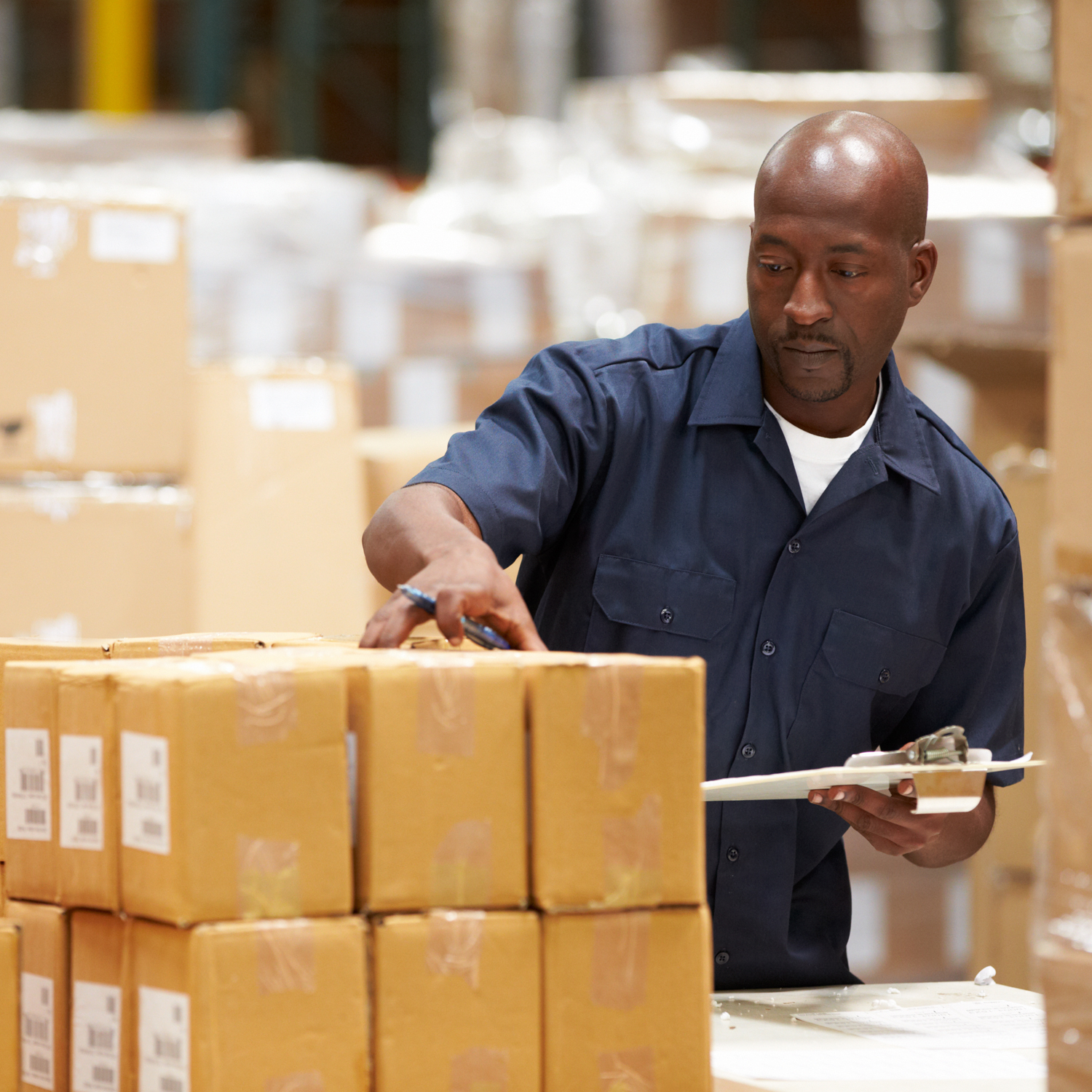 Man in warehouse checking parcels